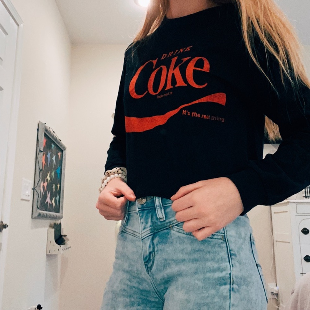 Cropped black long sleeve coke shirt.